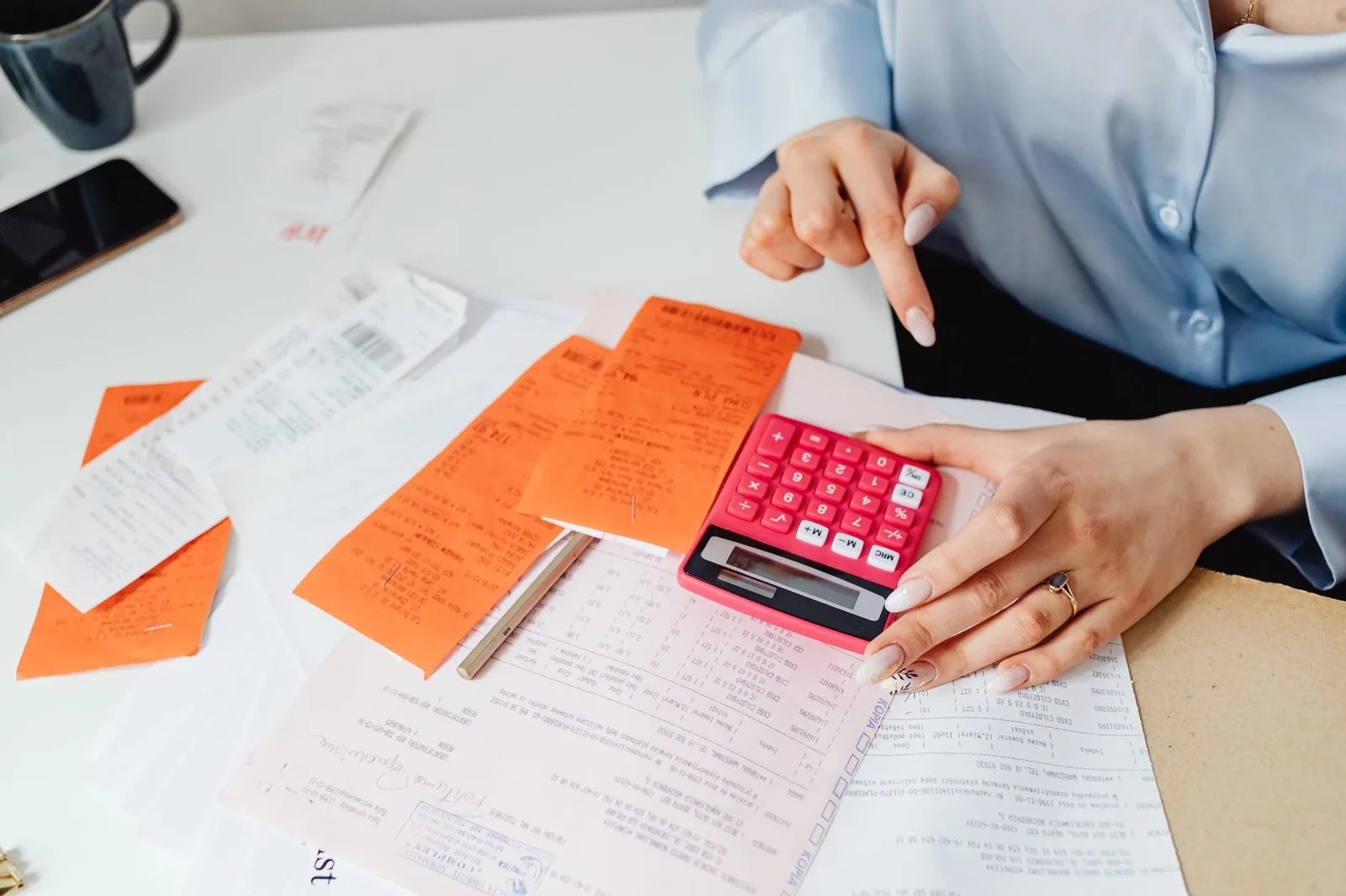 Calculator and spreadsheet on a desk used to estimate automation ROI before building a workflow