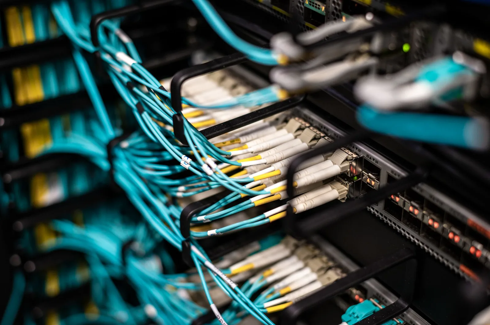 Dark server room with illuminated network cables representing AI agent framework security vulnerabilities