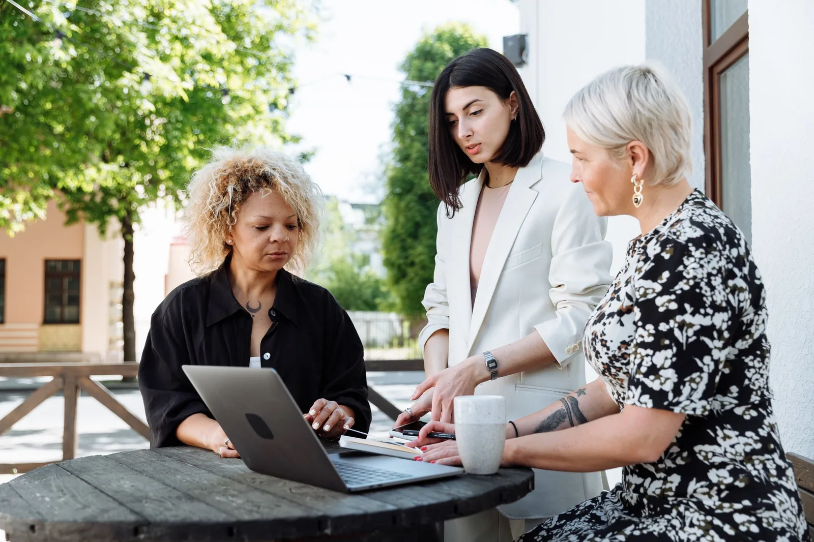 Small business team reviewing AI automation workflows on a laptop in a modern office setting